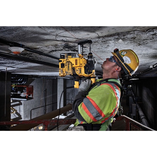 SDS Plus Rotary hammer being used by person to drill hole in  roof